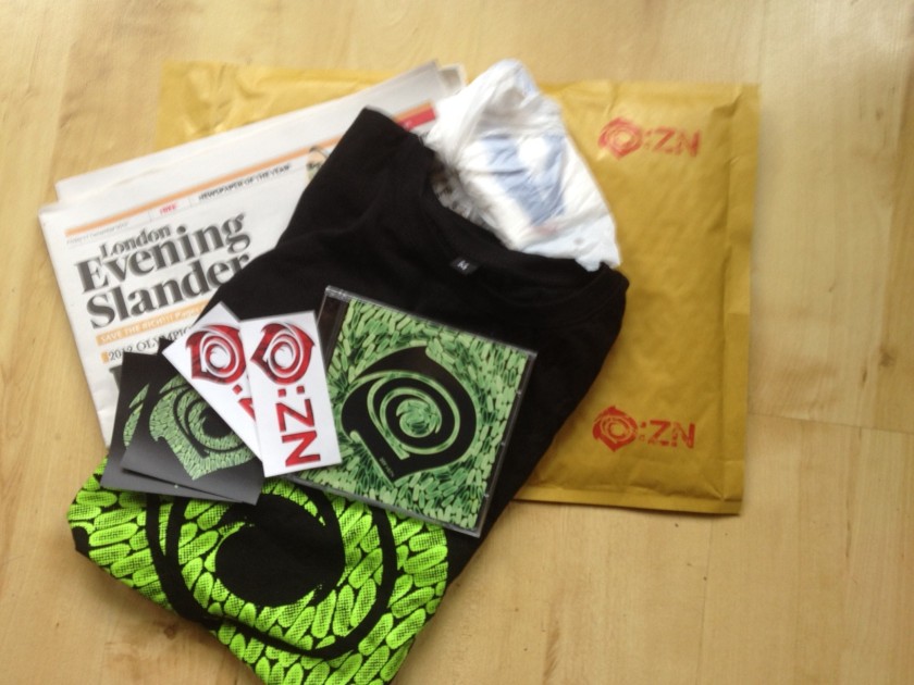 An O:ZN mailout pack, including CD, T-Shirt, stickers, survival kit and a copy of The Evening Slander.